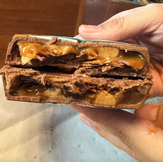 Dubai-Schokoladentafel mit Karamell und Erdnussbuttergeschmack, in zwei Hälften geöffnet